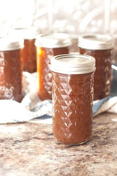 several jars filled with peanut butter sitting on top of a counter