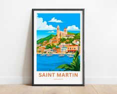 a framed poster with the name saint martin in front of a white wall and wooden floor