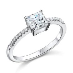 a white gold ring with a princess cut diamond and pave set diamonds on the band