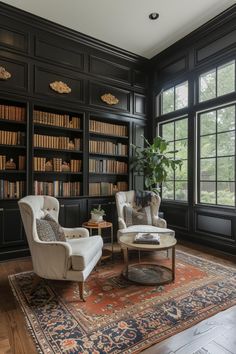 a living room with two chairs and a rug on the floor in front of large windows