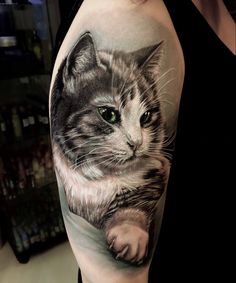 a woman with a cat tattoo on her arm