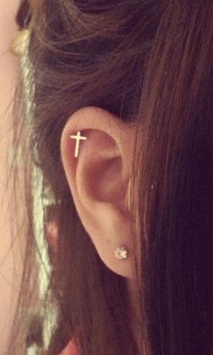 a woman's ear with a cross on it