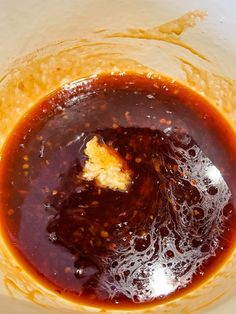 a bowl filled with sauce and bread on top of a table