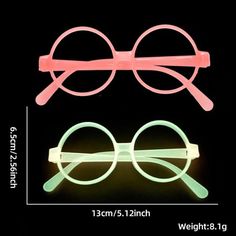 two pairs of glasses with pink and green frames on black background, one is glow in the dark