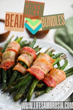 green bean bundles on a plate with bacon wrapped around them