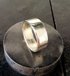 This hand forged coin ring is made out of a 90% silver US Walking Liberty Half Dollar Coin that has been filed down and no outer detail of the coin is visible.  Available in half size increments from 9-14 in a polished or natural satin finish. Band is slightly over 1/4 inch wide. Most, if not all, Walking Liberty coin rings will be made from coins from 1940-1947 due to overall condition and availability.  If the size you order is not to your liking, please send it back and we will resize it, within 1 size up or down, for you free of charge. Silver Hammered Signet Ring For Anniversary, Hand Forged Silver Ring With Thick Band, Silver Engraved Hammered Ring, Silver Hammered Wide Band Ring, Liberty Coin Pendant, Antique Silver Nickel-free Coin Necklace, Coin Rings, Half Dollar Coin, Dollar Coin