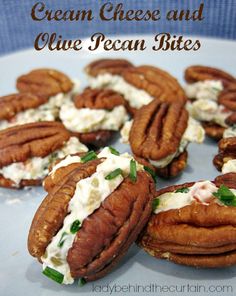 some pecans are sitting on a plate with cream cheese and blue pea bites in the middle