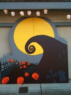 a garage door decorated for halloween with pumpkins