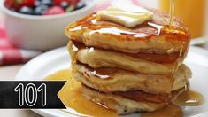 a stack of pancakes with syrup and butter being drizzled on top