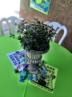 a green table topped with a potted plant