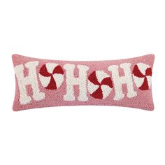 a pink and white pillow with the word h is for hearts on it