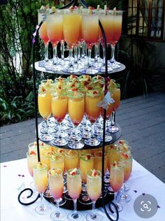 a tiered tray filled with drinks on top of a table