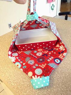 someone is opening an empty box on top of a countertop with flowers and polka dots