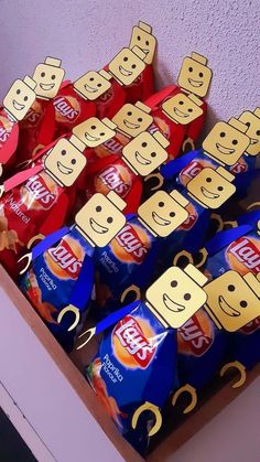 a box filled with lots of different types of candy bar on top of a table