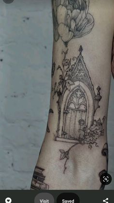 a woman's leg with a tattoo on it that has an image of a door