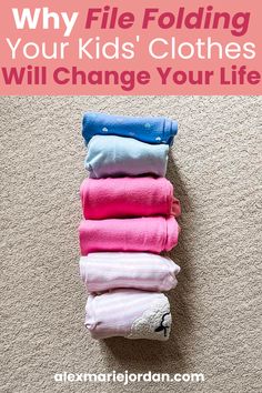 a pile of folded clothes on the floor with text overlay that reads why file folding your kids'clothes will change your life