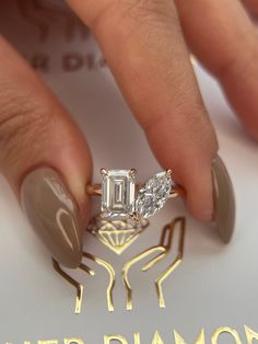 a woman's hand holding a diamond ring on top of her finger with the words diamonds written below it