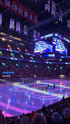 an ice hockey game in progress with the lights on