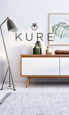 a living room with a white rug and a wooden cabinet in front of the wall