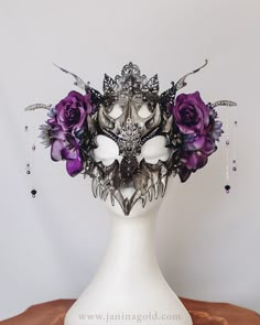 Unleash your inner dragon with this stunning black and silver dragon skull mask headpiece, adorned with exquisite purple flowers, lustrous pearls, and sparkling rhinestones. Perfect for Halloween, cosplay, or any occasion where you want to stand out, this headpiece is sure to turn heads and make a statement. Handcrafted with attention to detail, this unique accessory is both stylish and comfortable to wear. Shop now and make a bold fashion statement with this dragon skull mask headpiece! Gothic Masquerade Mask, Extravagant Masks, Dragon Skull Mask, Masquerade Mask Ideas, Purple Masquerade Mask, Cybergoth Fashion, Purple Mask, Masquerade Outfit, New Years Ball