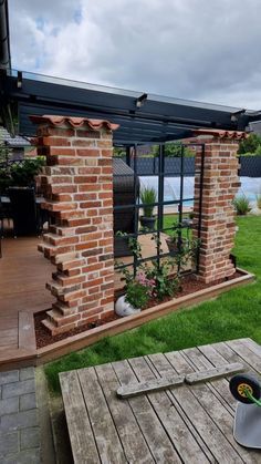 an outdoor patio area with a grill and picnic table