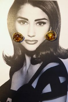 These stunning amber resin and gold swirl stud earrings combine vintage inspiration with modern elegance. Featuring a warm, amber-hued resin stone encased in a flowing gold-tone swirl, these earrings offer a beautiful organic shape that adds a touch of timeless sophistication to any outfit. The intricate design mimics natural forms, giving the earrings a unique, artisanal feel. Lightweight and comfortable, these statement earrings are perfect for both casual and formal occasions, offering a bold yet versatile look that can effortlessly elevate your style Amber Resin, Resin Stone, Amber Earrings, Vintage Inspiration, Natural Forms, Intricate Design, Organic Shapes, Modern Elegance, Vintage Earrings