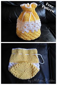 crocheted yellow and white diaper cover sitting on top of a black couch