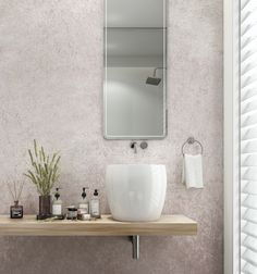 a bathroom sink sitting under a mirror next to a wooden counter