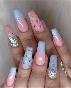 some pink and white nails with glitters on them