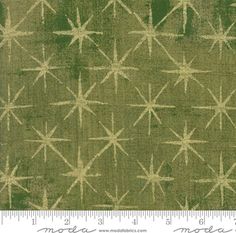 a green and white fabric with stars on the side, as well as a ruler