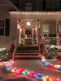 a house decorated with christmas lights and wreaths