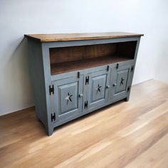 an old blue painted cabinet with stars on the doors