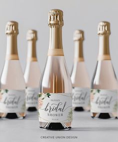 six bottles of bridal shower champagne on a table