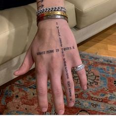 a person's hand with tattoos on it and the words, whats mine is yours?