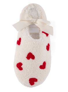 Your feet will thank you for kicking off your shoes and sliding into Shiraleah's Hearts Slippers. Closed toed and featuring a plush sherpa texture upon a rubber sole, these cozy house shoes are as sturdy as they are chic. The cute embroidered heart design adds a bit of playfulness to your new lounge wardrobe. Ribbon wrapped, this item makes a great gift option for yourself or others. Pair with other items from Shiraleah to complete the look! Color: Ivory S/M Fits Size 6-8 Polyester And Pvc Made Cozy White Slippers With Plush Lining, Cozy White Non-slip Slippers, White Comfortable Slippers For Gift, White Round Toe Slippers As Gift, White Round Toe Slippers Gift, Sherpa Texture, Ribbon Wrap, Embroidered Heart, Your Shoes