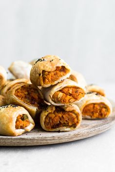 some food is stacked on top of each other and sitting on a wooden platter