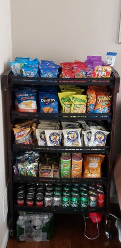 a shelf filled with lots of snacks and condiments next to a wall mounted mirror