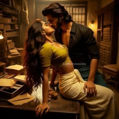 a man kissing a woman on the cheek while sitting in front of a book shelf