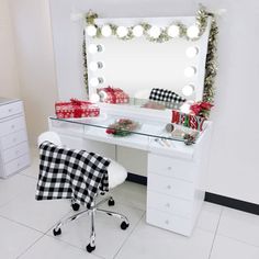 a desk with a mirror, chair and christmas decorations