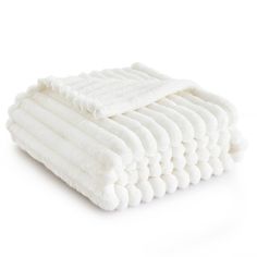 a stack of white towels folded on top of each other in front of a white background