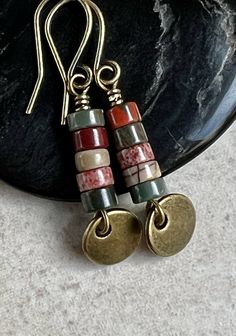 "red creek jasper earrings   small dangle boho earrings These earrings feature a small stack of Red Creek Jasper heishi stones. The earthy colors include green, golden yellow and rusty brown. Dangling below them is a small antiqued brass disc. Hook ear wires are antiqued brass. Length of earrings from top of ear wires is 1 1/2\". Jasper stones measure 4mm diameter. You can enter my shop here: gypsydangles.etsy.com" Bohemian Jasper Dangle Jewelry, Nickel Free Jasper Bohemian Jewelry, Bohemian Jasper Jewelry Nickel Free, Nickel-free Bohemian Jasper Jewelry, Multicolor Earthy Dangle Earrings, Earthy Multicolor Dangle Earrings, Jasper Dangle Earrings With Ear Wire, Nickel-free Jasper Earrings As Gift, Nickel-free Jasper Earrings For Gifts