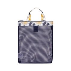 a blue and white tote bag with flowers on the front, sitting against a white background