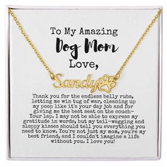 a necklace with the words to my amazing dog mom love written on it in gold