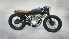 a black and brown motorcycle parked in a parking lot