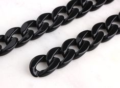 two black chains on a white surface