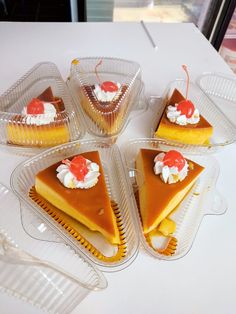 seven slices of pie in plastic containers on a table