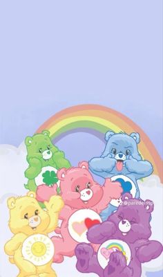 a group of teddy bears sitting in front of a rainbow