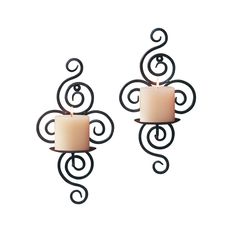 two wall sconces with candles in the shape of swirls on each side