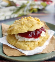 a close up of a plate of food with cookies and jelly on it, along with napkins