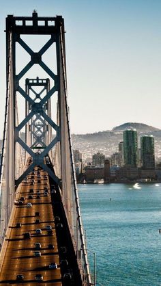 cars are driving on the bridge over the water